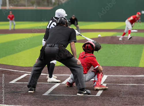 Young boys playing in high school baseball game photo