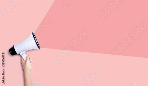 Person holding a megaphone with hard shadow