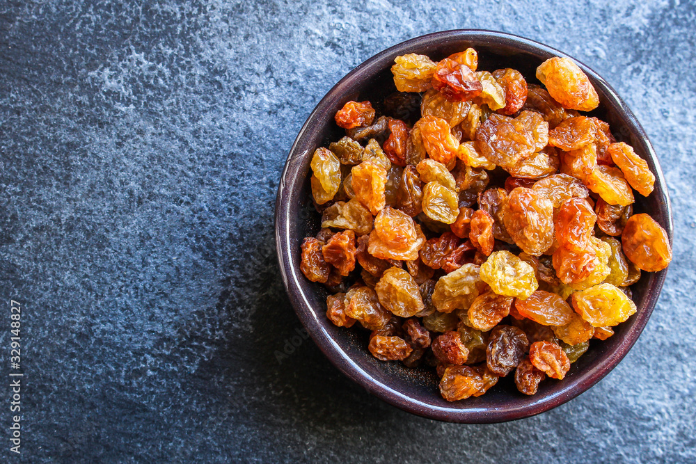 raisins, delicious dried grapes (fresh fruit vitamins) menu concept background. top view. copy space for text raisins, delicious dried grapes (fresh fruit vitamins) menu concept background. top view. copy space for text