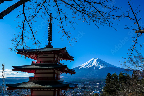View on Chureito Pagoda and mountain of the mountains Mt Fuji  Japan  captured on a clear  sunny day in winter. Top of the volcano covered with snow. Trees aren t blossoming yet. Postcard from Japan.
