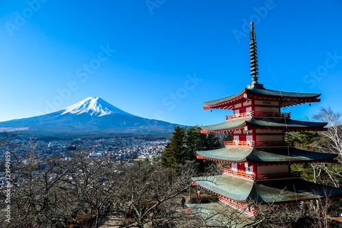 View on Chureito Pagoda and mountain of the mountains Mt Fuji  Japan  captured on a clear  sunny day in winter. Top of the volcano covered with snow. Trees aren t blossoming yet. Postcard from Japan.