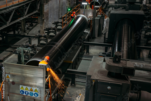 Wallpaper Mural Male workers grinding butt weld pipe in metalwork workshop Torontodigital.ca