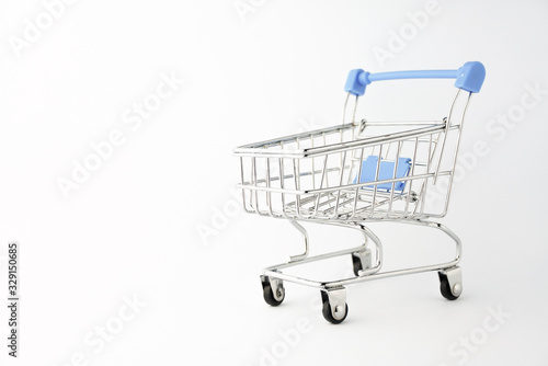 Small shopping trolley on the white background