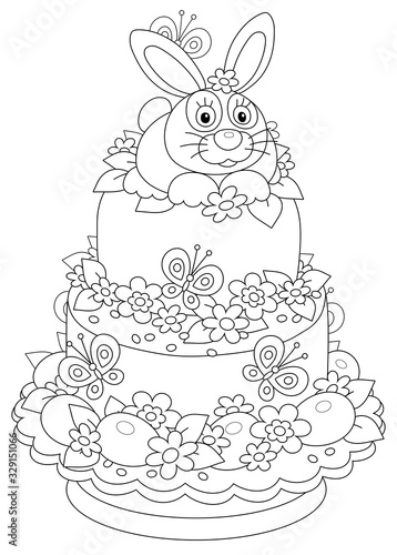 Fancy Easter cake with a cute bunny, beautiful flowers, painted eggs and flittering funny butterflies, black and white vector cartoon illustration for a coloring book page