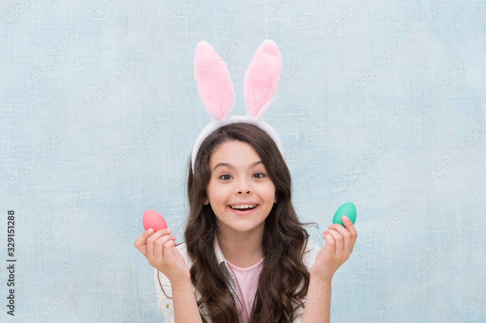Playful child with dyed eggs. Meet spring holiday. Girl little child easter bunny accessory. Shopping for holiday attributes. Easter eggs. Origin of easter bunny. Easter symbols and traditions Playful child with dyed eggs. Meet spring holiday. Girl little child easter bunny accessory. Shopping for holiday attributes. Easter eggs. Origin of easter bunny. Easter symbols and traditions