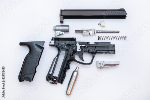 Dismantling a pneumatic gun top view, on a white background