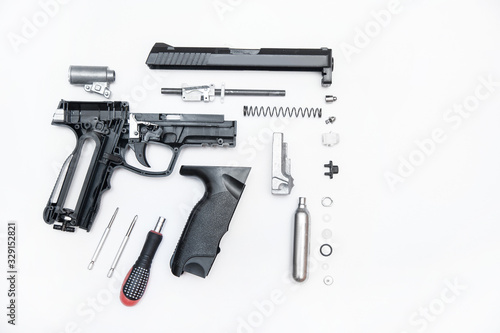 pistol parts neatly folded on a white background