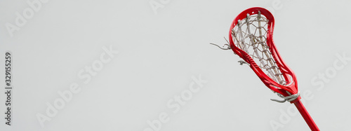 Konstfotografi Lacrosse red stick against the white wall