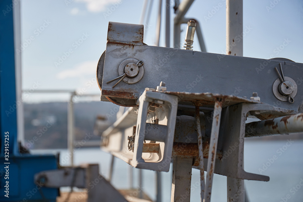 Industrial metal structures at a dam, steel metal beams, axles fixed by cotter pin Industrial metal structures at a dam, steel metal beams, axles fixed by cotter pin