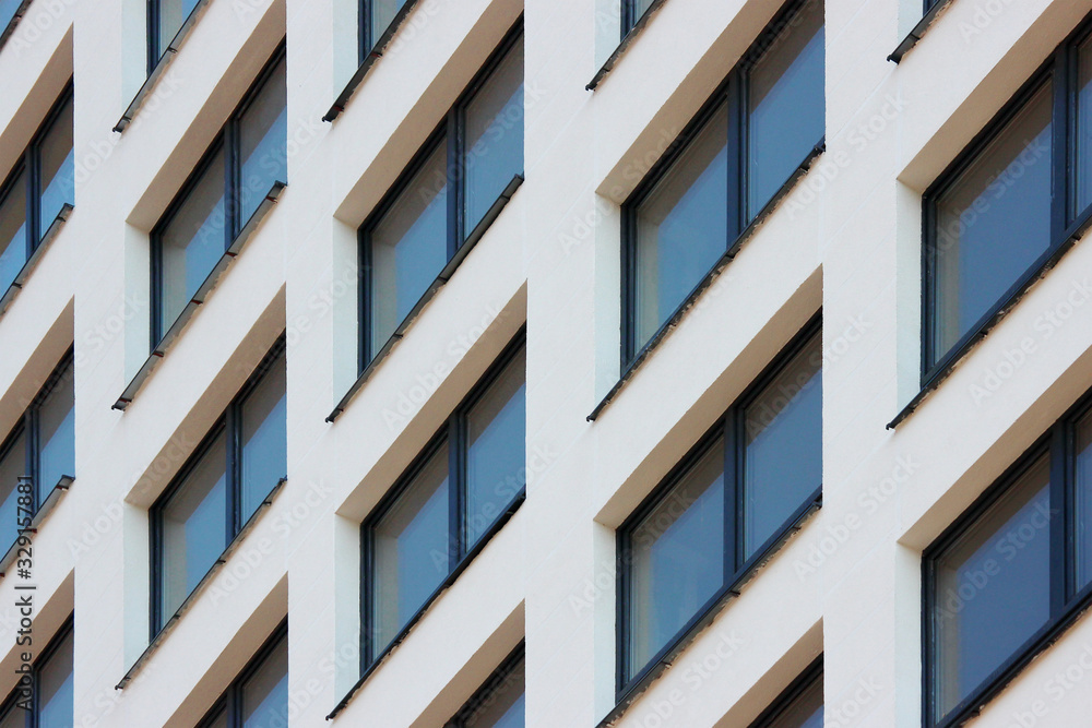 Parts of the modern facade of apartment buildings made of glass and concrete with highlights on the windows in beige colors. Trends in buildings Parts of the modern facade of apartment buildings made of glass and concrete with highlights on the windows in beige colors. Trends in buildings