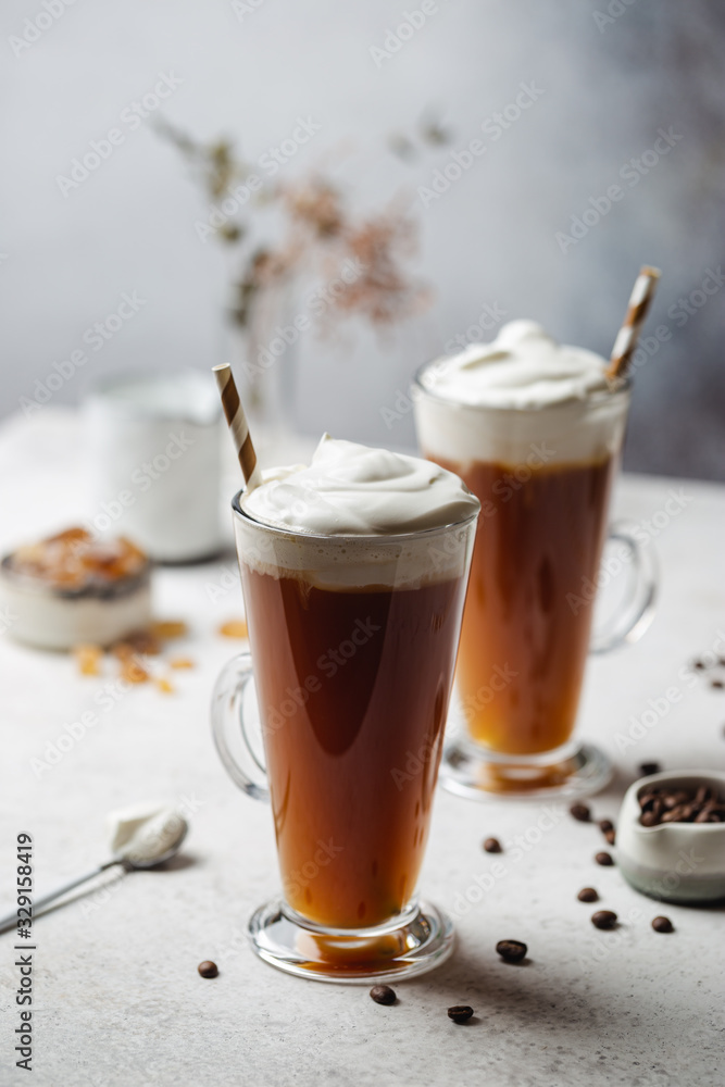 Iced coffee in a tall glasses with cream poured over Iced coffee in a tall glasses with cream poured over