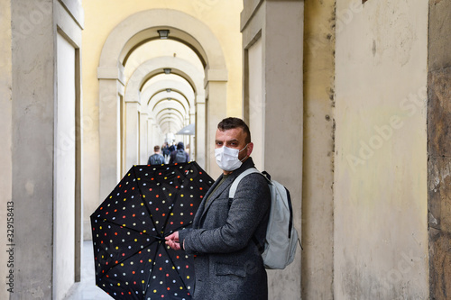 Coronavirus Covid-2019 in Italy. man in  protective medical mask in the historic center of Florence. empty Italian streets without tourists. Coronavirus in Venice Milan Lombardy Rome photo