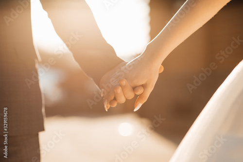 Wedding couple holding hands. Hands of the lovers of the bride and groom. Wedding rings