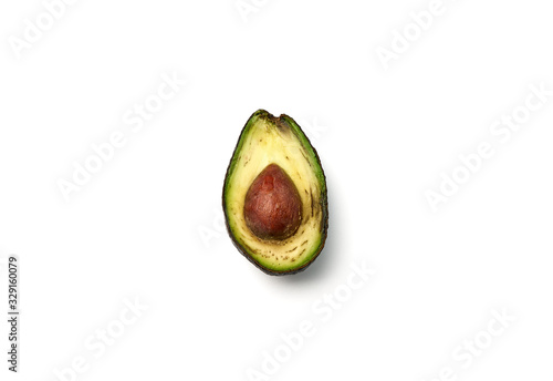 A rotten avocado cut in half on white background. Avocado is rotten and no longer good to eat.