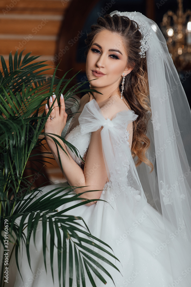 Portrait of beautiful woman with palm leaf. Perfect skin. Beautiful young woman with clean fresh skin face in the leaves of the palm trees. Young bride posing Portrait of beautiful woman with palm leaf. Perfect skin. Beautiful young woman with clean fresh skin face in the leaves of the palm trees. Young bride posing