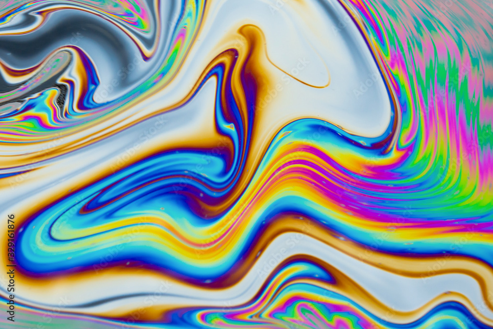 Psychedelic abstract background. Photo macro shot with light interference on the surface of a soap bubble Psychedelic abstract background. Photo macro shot with light interference on the surface of a soap bubble