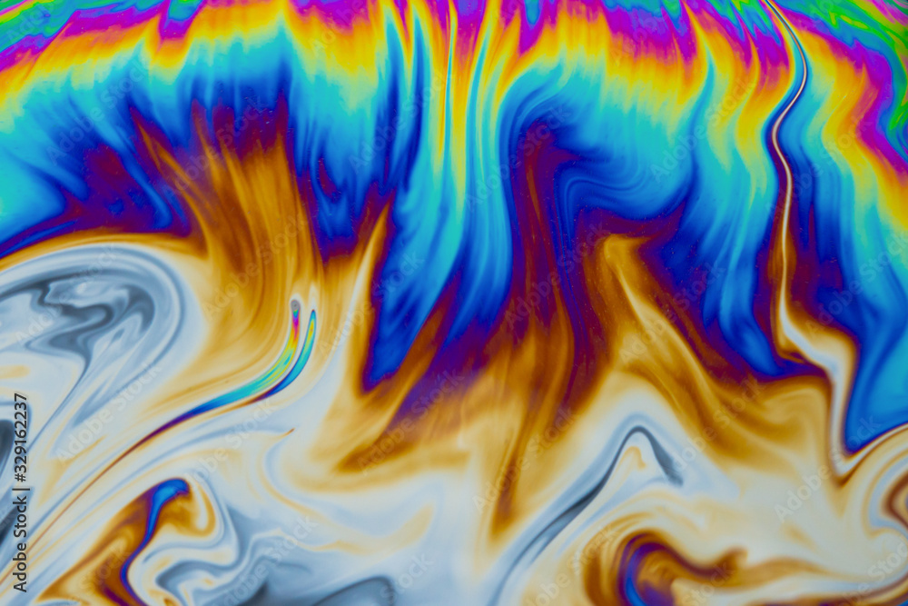 Obraz premium Psychedelic abstract background. Photo macro shot with light interference on the surface of a soap bubble