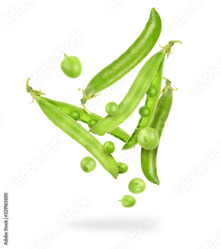 Uncovered pea pods in the air on a white background photo