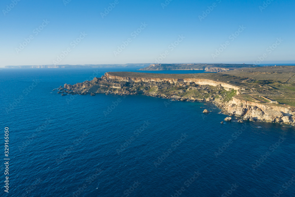 Aerial drone view of rocky coastline and sea. Malta