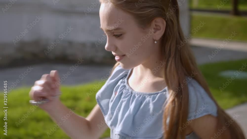 Charming long-haired girl happy smiles, enjoys sunny day, dancing happy Charming long-haired girl happy smiles, enjoys sunny day, dancing happy