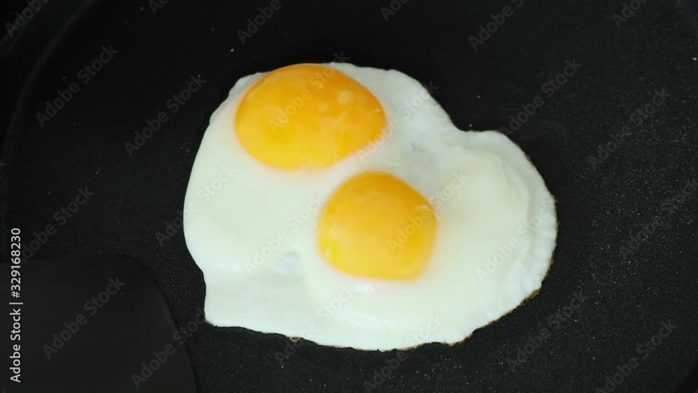 Cooking Fried eggs in pan on stove. Close up. Cooking Fried eggs in pan on stove. Close up.
