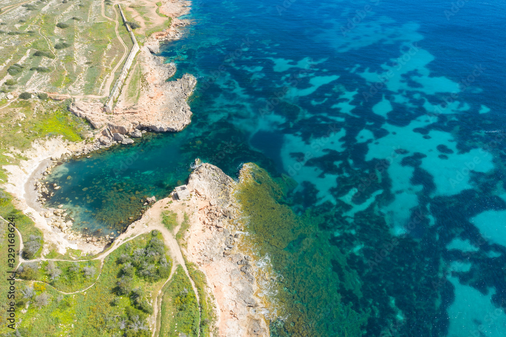 Aerial drone view of rocky coastline and sea. Malta