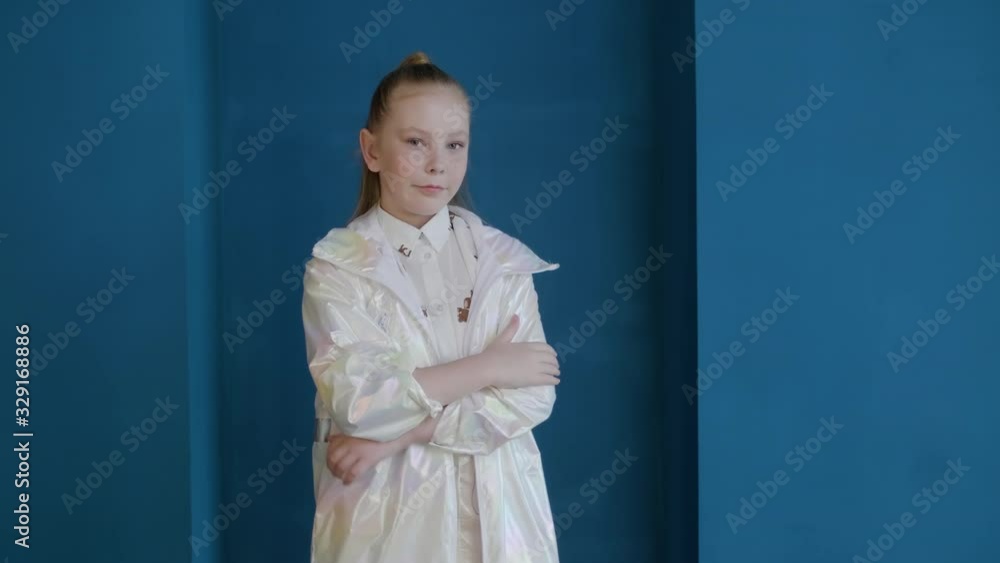 Beautiful teen girl wearing white coat posing in studio. Attractive young lady with ponytail posing during photo session. Girls beauty concept Beautiful teen girl wearing white coat posing in studio. Attractive young lady with ponytail posing during photo session. Girls beauty concept