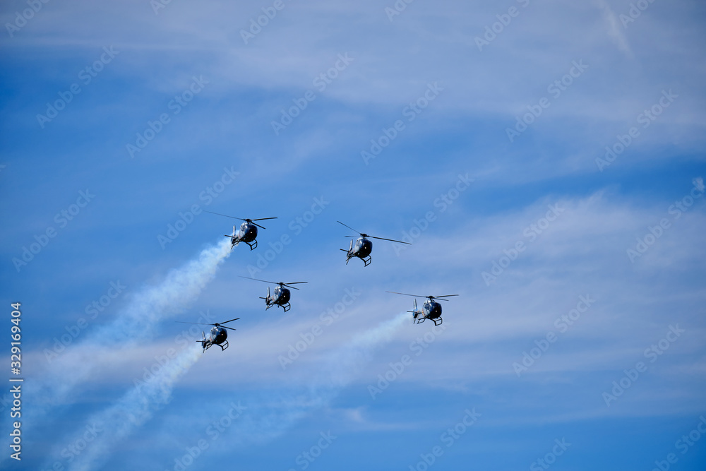 formation of five helicopters over sky with clouds formation of five helicopters over sky with clouds