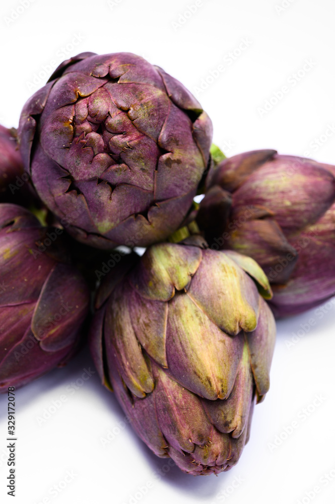 Fototapeta premium Heads of raw fresh purple artichoke plant ready to cook