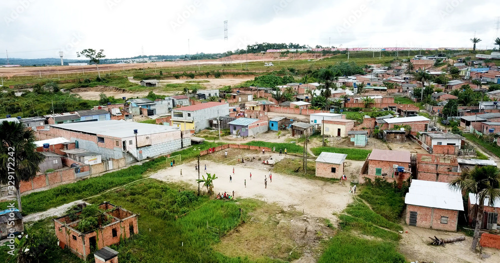 Manaus/Amazonas/Brazil - 10/10/2018 - poor children playing futebol in a sand field at slum.