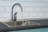 Kitchen sink and water tap in the kitchen in a modern apartment. Domestic Appliances