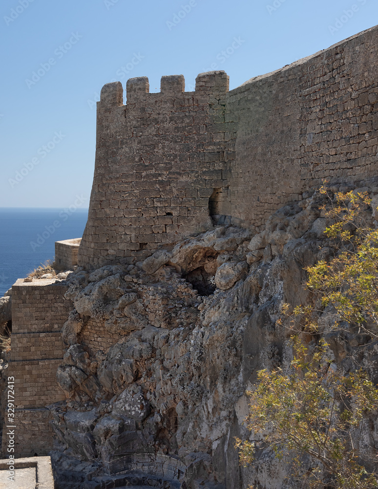 view of the wall of an ancient fortress. The element of the defense wall on the background of the sea surface