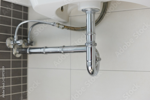Принти на полотні metal sink siphon and drain in white bathroom