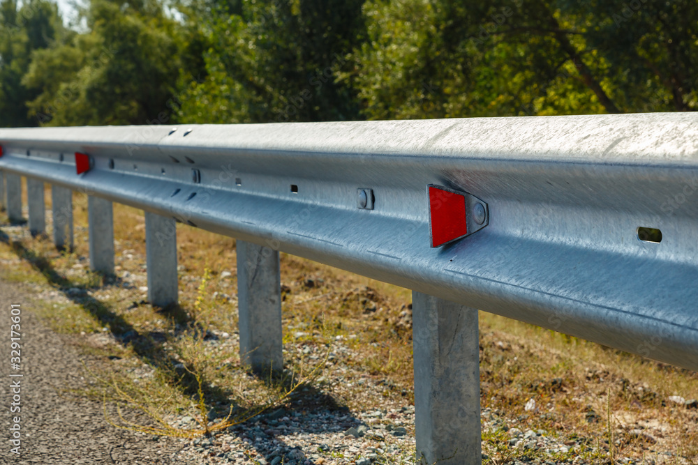 red road reflectors along the road. metal road fencing of barrier type. Road and traffic safety red road reflectors along the road. metal road fencing of barrier type. Road and traffic safety
