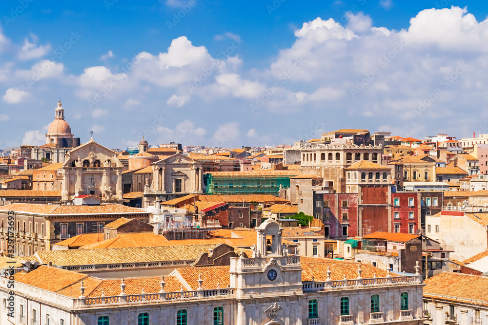 Aerial skyline panoramic view of Catania in September,  old town featuring brown and yellow roofs with Mount Etna at background. Sicily, Italy 
