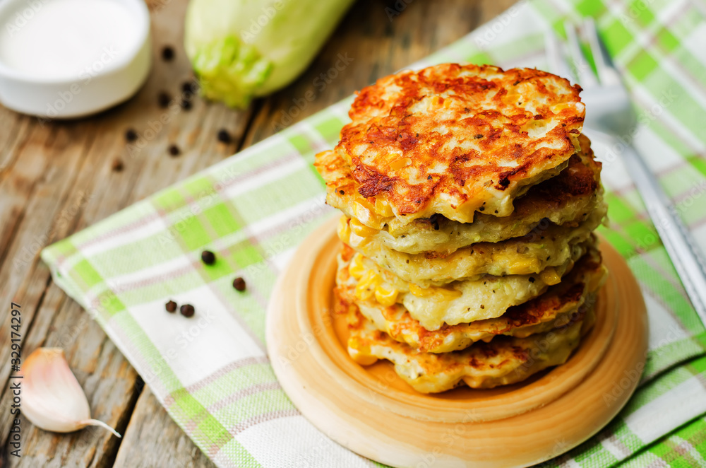 zucchini corn fritters on a wood background zucchini corn fritters on a wood background