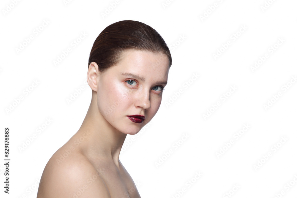 Portrait of young beautiful woman with nude eye makeup and dark red lipstick over white background Portrait of young beautiful woman with nude eye makeup and dark red lipstick over white background