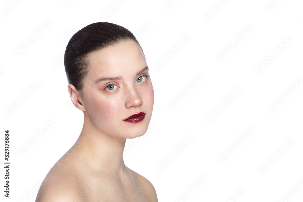 Portrait of young beautiful woman with nude eye makeup and dark red lipstick over white background Portrait of young beautiful woman with nude eye makeup and dark red lipstick over white background