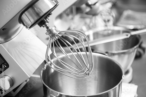 Photos Professional steel electric mixer for kneading dough, cream in restaurant kitche