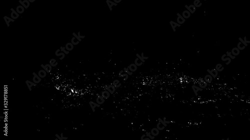 Droplets of rain falling on the surface creating splashes on an isolated background