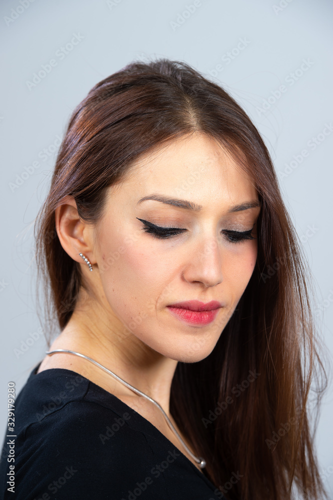 Studio portrait of a beautiful young woman with long straight hair and sexy make up Studio portrait of a beautiful young woman with long straight hair and sexy make up