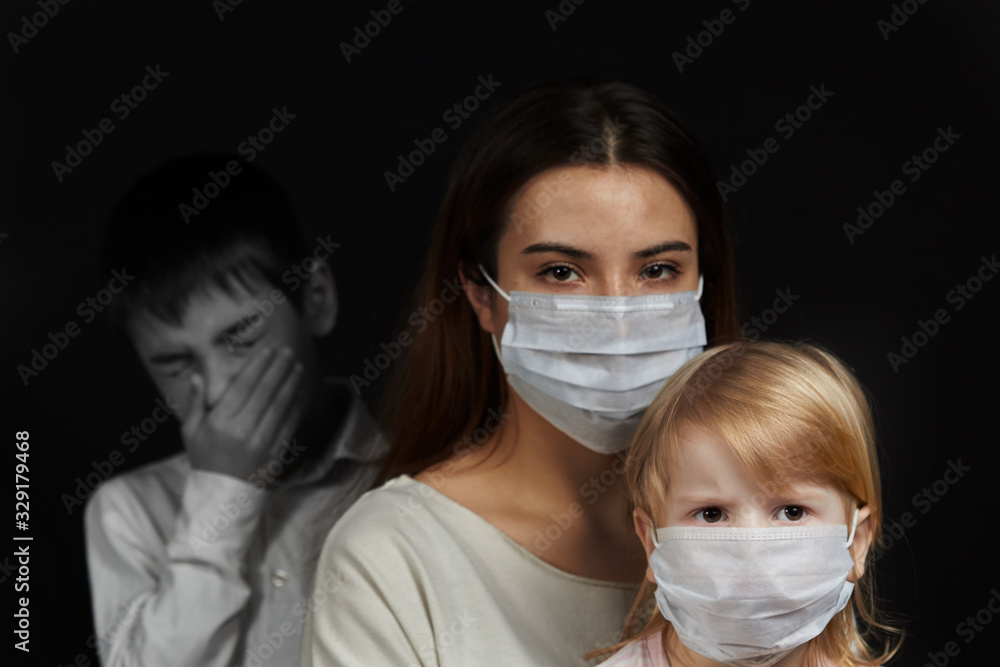 masked girl and boy sneezing, the concept of protection against the spread of the virus medical mask