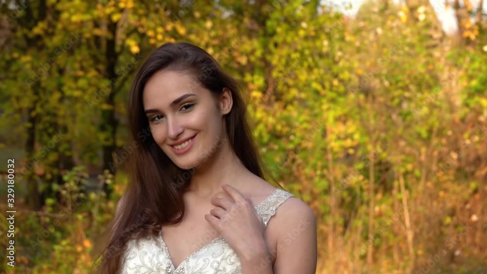 Beautiful bride is posing at the sunset against autumn nature. Video shooting movement camera with steadicam. Beautiful bride is posing at the sunset against autumn nature. Video shooting movement camera with steadicam.