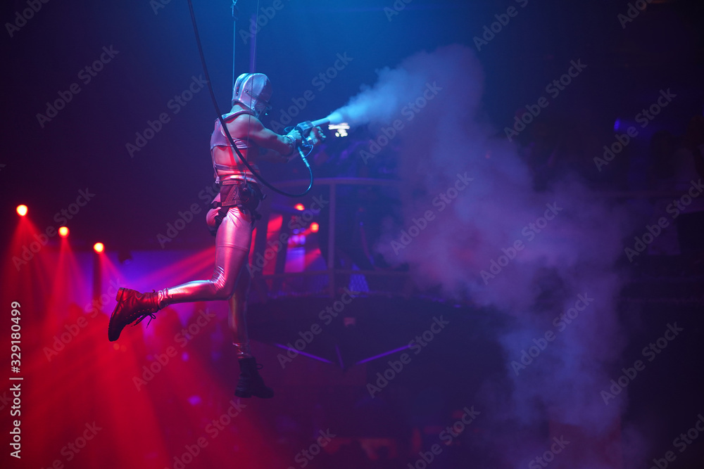 Air performance in night club. Sport training gym and lifestyle concept. Black background Circus show