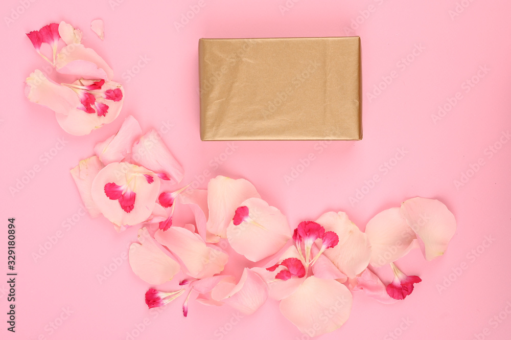 Top view of gift boxes, flowers petals isolated on pink with copy space