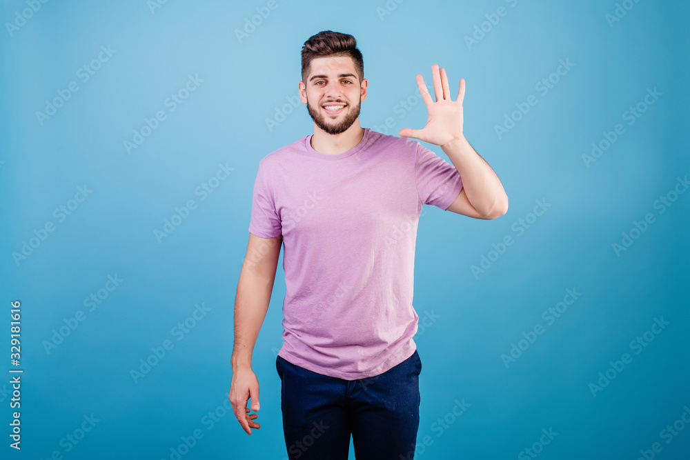 smiling man showing five fingers isolated on blue background smiling man showing five fingers isolated on blue background