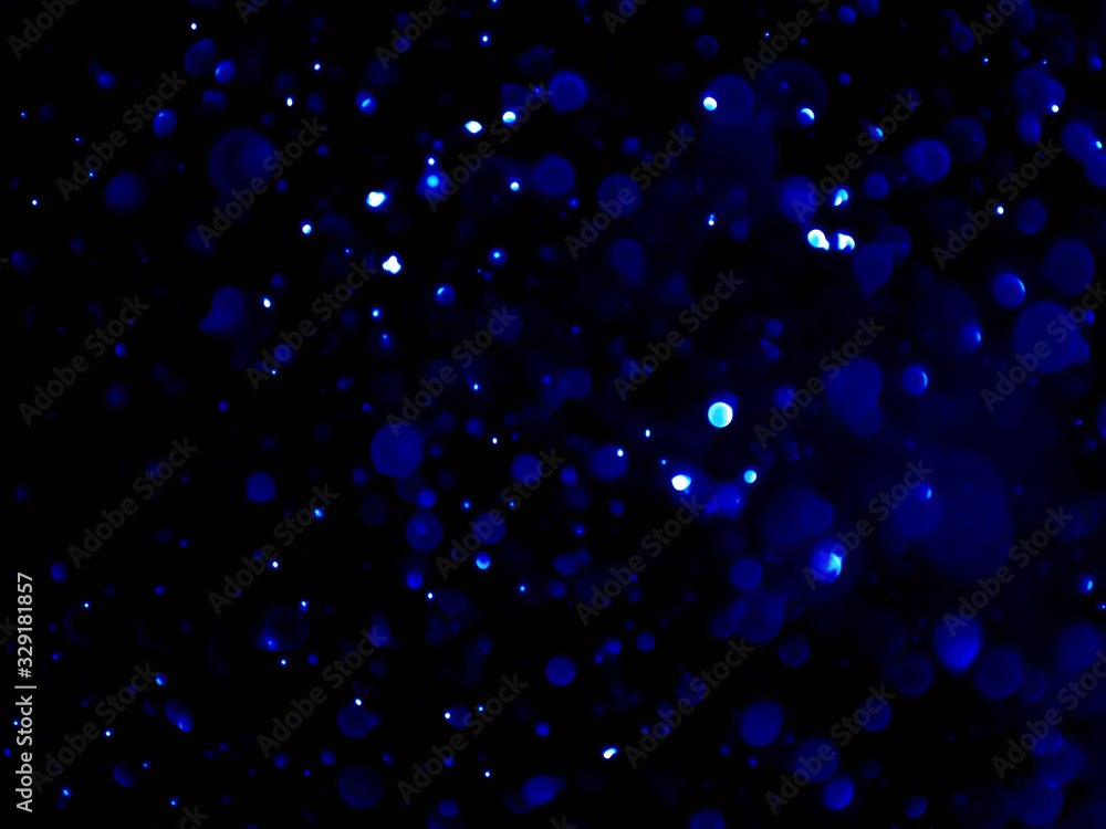 Abstract blue bokeh texture on black background. Abstract blue bokeh texture on black background.