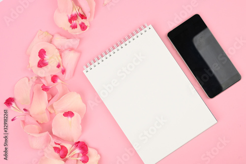Female desktop with roses, notebook and smartphone. Spring minimal concept. Space for text © SYARGEENKA
