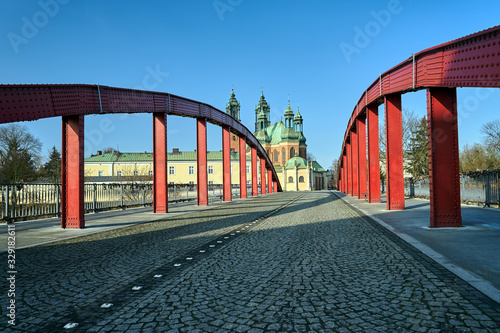 The steel structure of the bridge and the towers of the Gothic Catholic cathedral in Poznan.