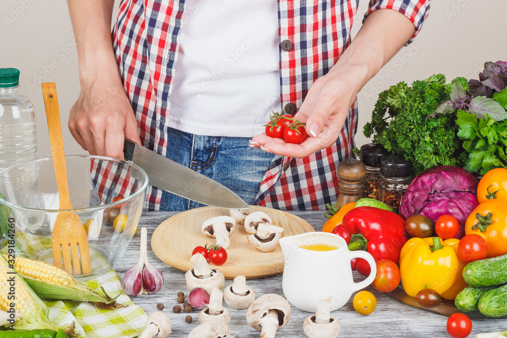 Woman cooks at the kitchen, body part, blurred background Woman cooks at the kitchen, body part, blurred background